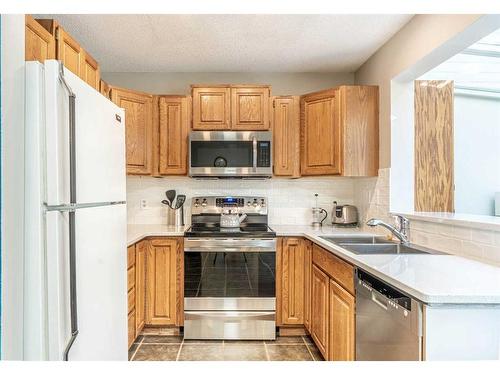 104 Millbank Close Sw, Calgary, AB - Indoor Photo Showing Kitchen With Double Sink