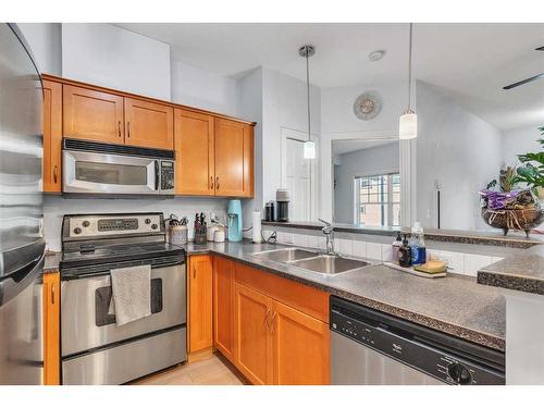 208-1408 17 Street Se, Calgary, AB - Indoor Photo Showing Kitchen With Double Sink