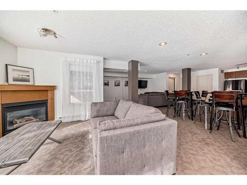 228-22 Richard Place Sw, Calgary, AB - Indoor Photo Showing Living Room With Fireplace