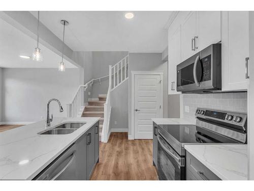 957 Cobblemore Common Sw, Airdrie, AB - Indoor Photo Showing Kitchen With Double Sink With Upgraded Kitchen