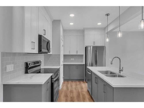 957 Cobblemore Common Sw, Airdrie, AB - Indoor Photo Showing Kitchen With Double Sink With Upgraded Kitchen