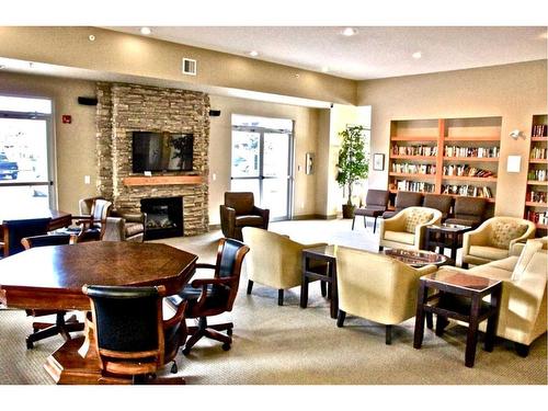 4209-92 Crystal Shores Road, Okotoks, AB - Indoor Photo Showing Dining Room With Fireplace