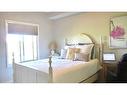 4209-92 Crystal Shores Road, Okotoks, AB  - Indoor Photo Showing Bedroom 