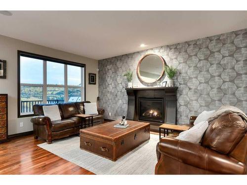 263 Sunset View, Cochrane, AB - Indoor Photo Showing Living Room With Fireplace