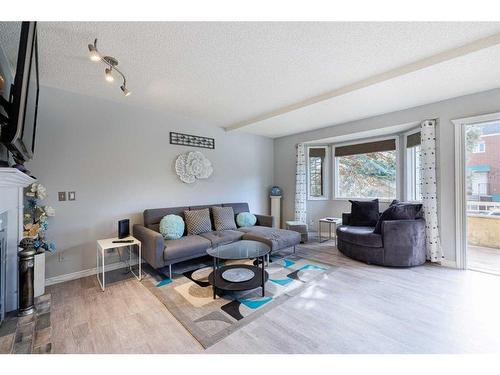 7 Richelieu Court Sw, Calgary, AB - Indoor Photo Showing Living Room With Fireplace