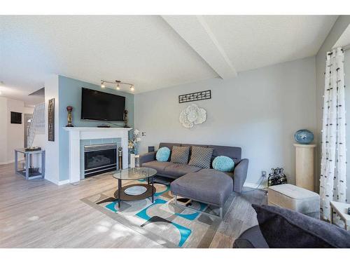 7 Richelieu Court Sw, Calgary, AB - Indoor Photo Showing Living Room With Fireplace