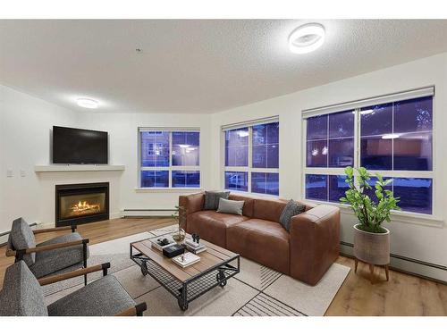 155-35 Richard Court Sw, Calgary, AB - Indoor Photo Showing Living Room With Fireplace