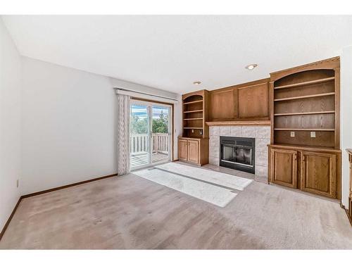 513 Hawkstone Drive Nw, Calgary, AB - Indoor Photo Showing Living Room With Fireplace