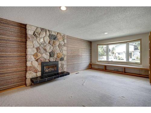 5848 Lodge Crescent Sw, Calgary, AB - Indoor Photo Showing Living Room With Fireplace