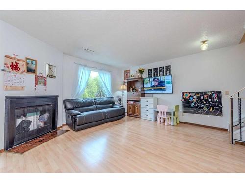 23-2511 38 Street Ne, Calgary, AB - Indoor Photo Showing Living Room With Fireplace