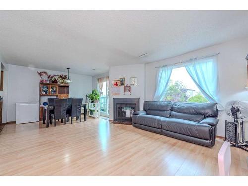 23-2511 38 Street Ne, Calgary, AB - Indoor Photo Showing Living Room With Fireplace