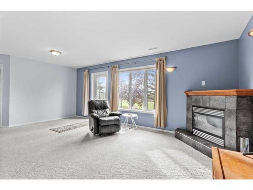 752 Stonehaven Drive, Carstairs, AB - Indoor Photo Showing Living Room With Fireplace