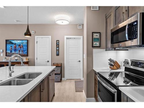 310-106 Stewart Creek Rise, Canmore, AB - Indoor Photo Showing Kitchen With Double Sink With Upgraded Kitchen