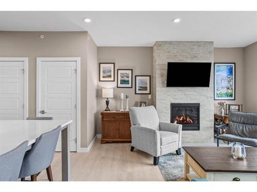 310-106 Stewart Creek Rise, Canmore, AB - Indoor Photo Showing Living Room With Fireplace