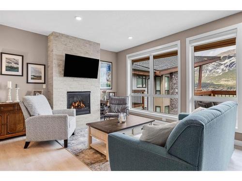 310-106 Stewart Creek Rise, Canmore, AB - Indoor Photo Showing Living Room With Fireplace