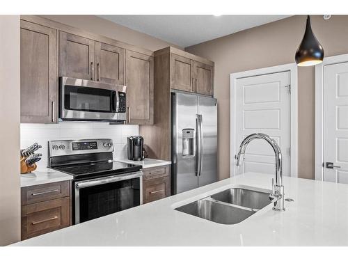 310-106 Stewart Creek Rise, Canmore, AB - Indoor Photo Showing Kitchen With Double Sink With Upgraded Kitchen