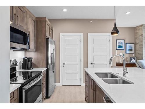 310-106 Stewart Creek Rise, Canmore, AB - Indoor Photo Showing Kitchen With Double Sink With Upgraded Kitchen