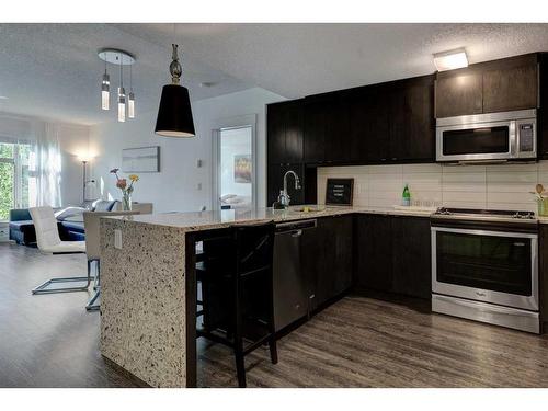 219-15 Aspenmont Heights Sw, Calgary, AB - Indoor Photo Showing Kitchen With Stainless Steel Kitchen With Upgraded Kitchen