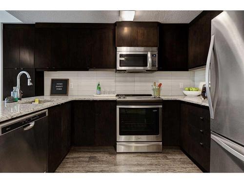 219-15 Aspenmont Heights Sw, Calgary, AB - Indoor Photo Showing Kitchen With Stainless Steel Kitchen With Upgraded Kitchen