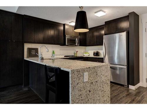 219-15 Aspenmont Heights Sw, Calgary, AB - Indoor Photo Showing Kitchen With Stainless Steel Kitchen With Upgraded Kitchen