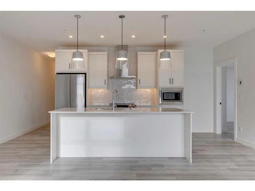 103-60 Sage Hill Walk Nw, Calgary, AB - Indoor Photo Showing Kitchen With Double Sink With Upgraded Kitchen