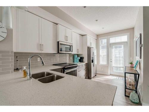 40 Legacy Path Se, Calgary, AB - Indoor Photo Showing Kitchen With Stainless Steel Kitchen With Double Sink With Upgraded Kitchen