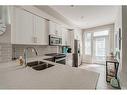 40 Legacy Path Se, Calgary, AB  - Indoor Photo Showing Kitchen With Stainless Steel Kitchen With Double Sink With Upgraded Kitchen 