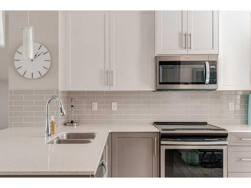 40 Legacy Path Se, Calgary, AB - Indoor Photo Showing Kitchen With Stainless Steel Kitchen With Double Sink With Upgraded Kitchen