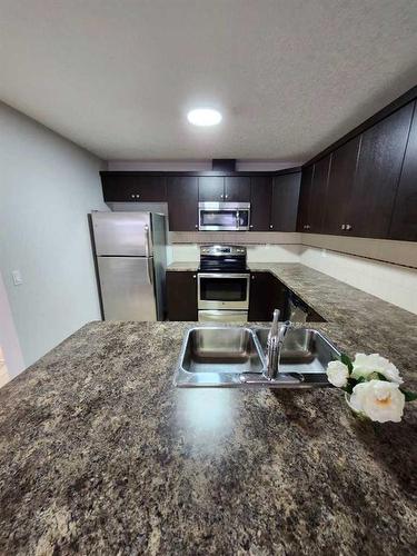 124 Windstone Link Sw, Airdrie, AB - Indoor Photo Showing Kitchen With Double Sink