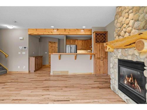 102-800 Wilson Way, Canmore, AB - Indoor Photo Showing Living Room With Fireplace