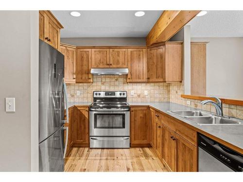 102-800 Wilson Way, Canmore, AB - Indoor Photo Showing Kitchen With Stainless Steel Kitchen With Double Sink