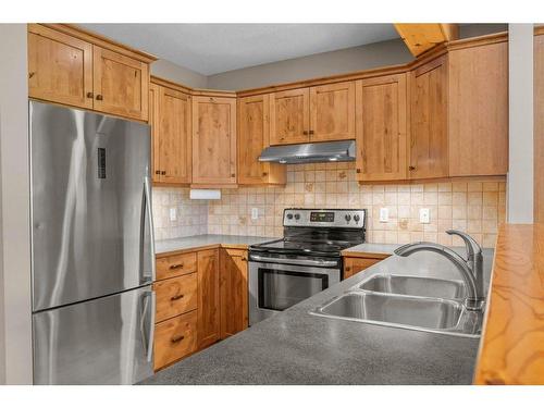 102-800 Wilson Way, Canmore, AB - Indoor Photo Showing Kitchen With Stainless Steel Kitchen With Double Sink