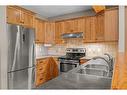 102-800 Wilson Way, Canmore, AB  - Indoor Photo Showing Kitchen With Stainless Steel Kitchen With Double Sink 