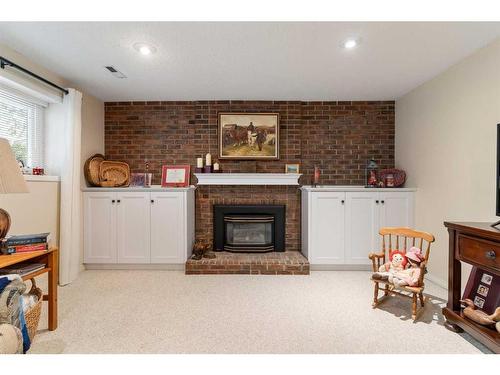 2931 Palliser Drive Sw, Calgary, AB - Indoor Photo Showing Living Room With Fireplace