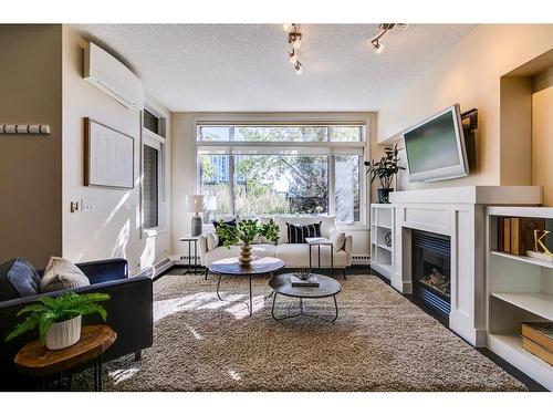 115-950 Centre Avenue Ne, Calgary, AB - Indoor Photo Showing Living Room With Fireplace