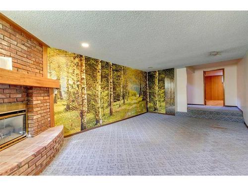 48 Malibou Road Sw, Calgary, AB - Indoor With Fireplace