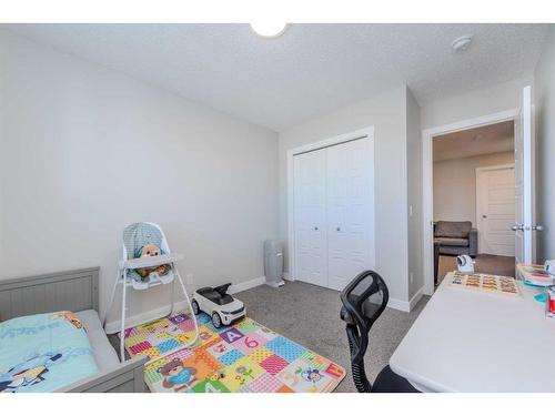 831 Creekside Boulevard Sw, Calgary, AB - Indoor Photo Showing Bedroom