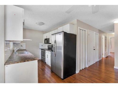 15 Falworth Place Ne, Calgary, AB - Indoor Photo Showing Kitchen With Double Sink