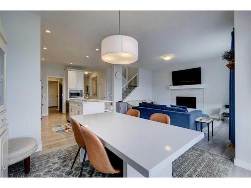 60 Morgan Street, Cochrane, AB - Indoor Photo Showing Dining Room With Fireplace