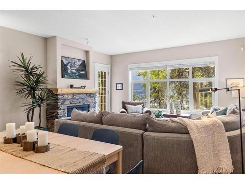 102-3 Aspen Glen, Canmore, AB - Indoor Photo Showing Living Room With Fireplace