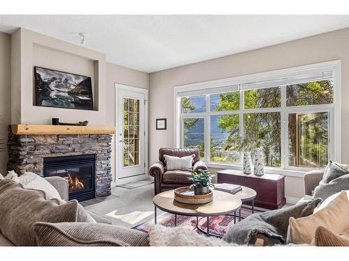 102-3 Aspen Glen, Canmore, AB - Indoor Photo Showing Living Room With Fireplace