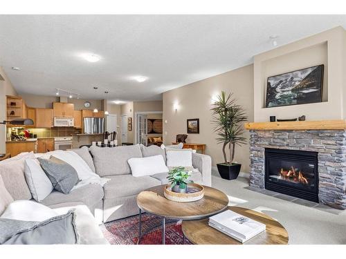 102-3 Aspen Glen, Canmore, AB - Indoor Photo Showing Living Room With Fireplace