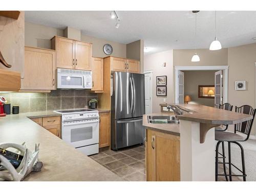 102-3 Aspen Glen, Canmore, AB - Indoor Photo Showing Kitchen With Double Sink