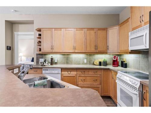 102-3 Aspen Glen, Canmore, AB - Indoor Photo Showing Kitchen With Double Sink