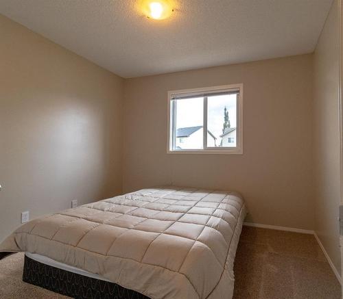 198 Sunset Heights, Cochrane, AB - Indoor Photo Showing Bedroom