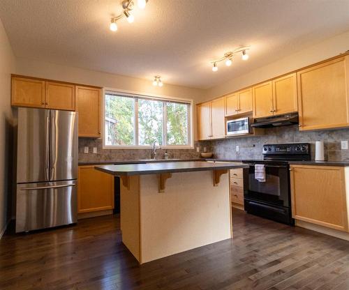 198 Sunset Heights, Cochrane, AB - Indoor Photo Showing Kitchen With Stainless Steel Kitchen