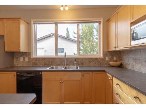 198 Sunset Heights, Cochrane, AB - Indoor Photo Showing Kitchen With Double Sink