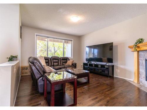 198 Sunset Heights, Cochrane, AB - Indoor Photo Showing Living Room With Fireplace