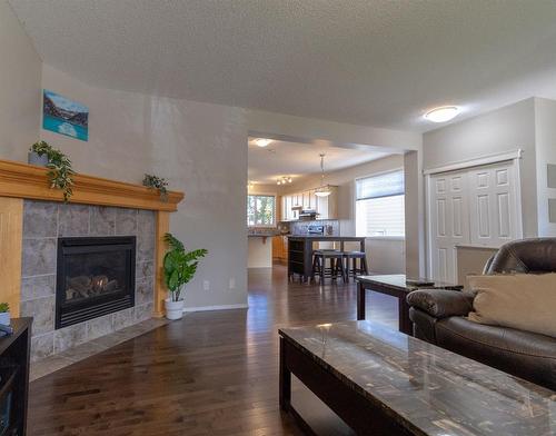 198 Sunset Heights, Cochrane, AB - Indoor Photo Showing Living Room With Fireplace