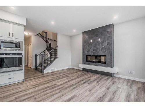 158 Aquila Way Nw, Calgary, AB - Indoor Photo Showing Living Room With Fireplace